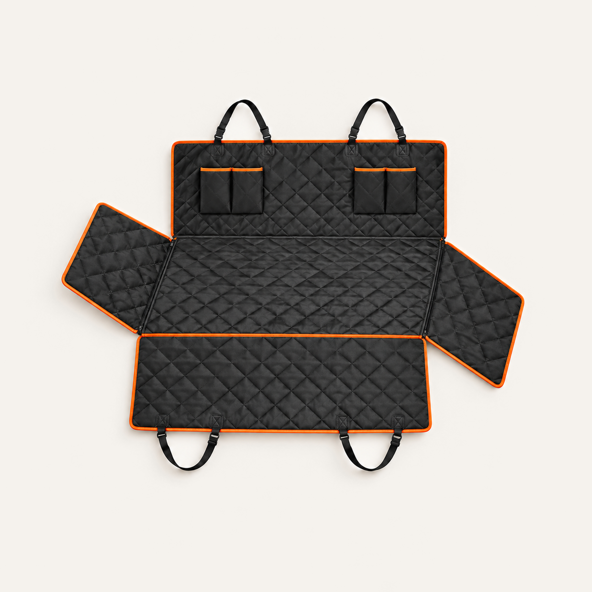 Black quilted dog car seat hammock with orange trim on a warm neutral background