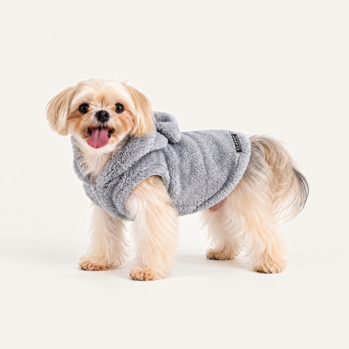 Plush Fleece Dog Hoodie worn by a dog on a warm neutral studio background
